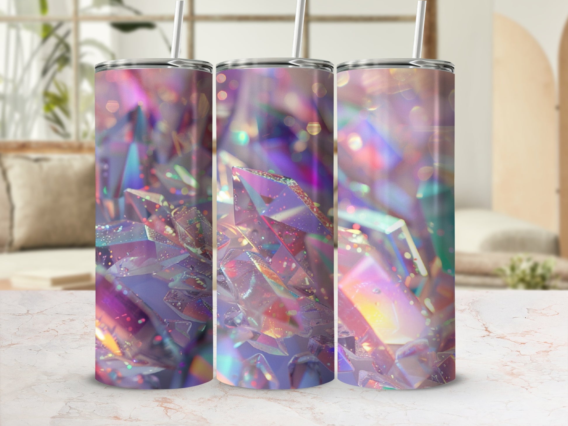 Three tumblers with iridescent crystal-like patterns on a marble surface.