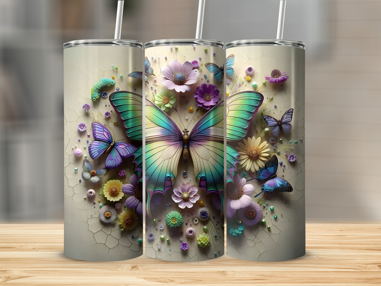 Three tall tumblers with colorful butterflies and floral designs.