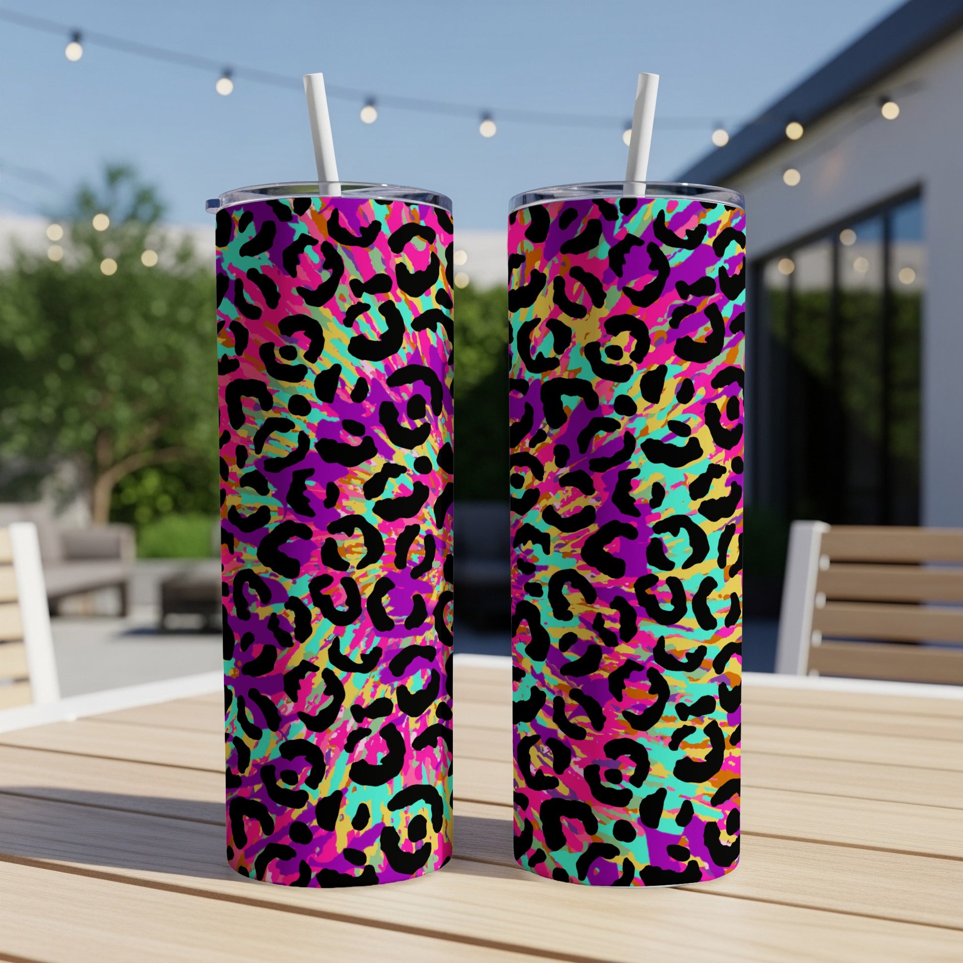 Two tumblers with a vibrant neon leopard print pattern and white straws.