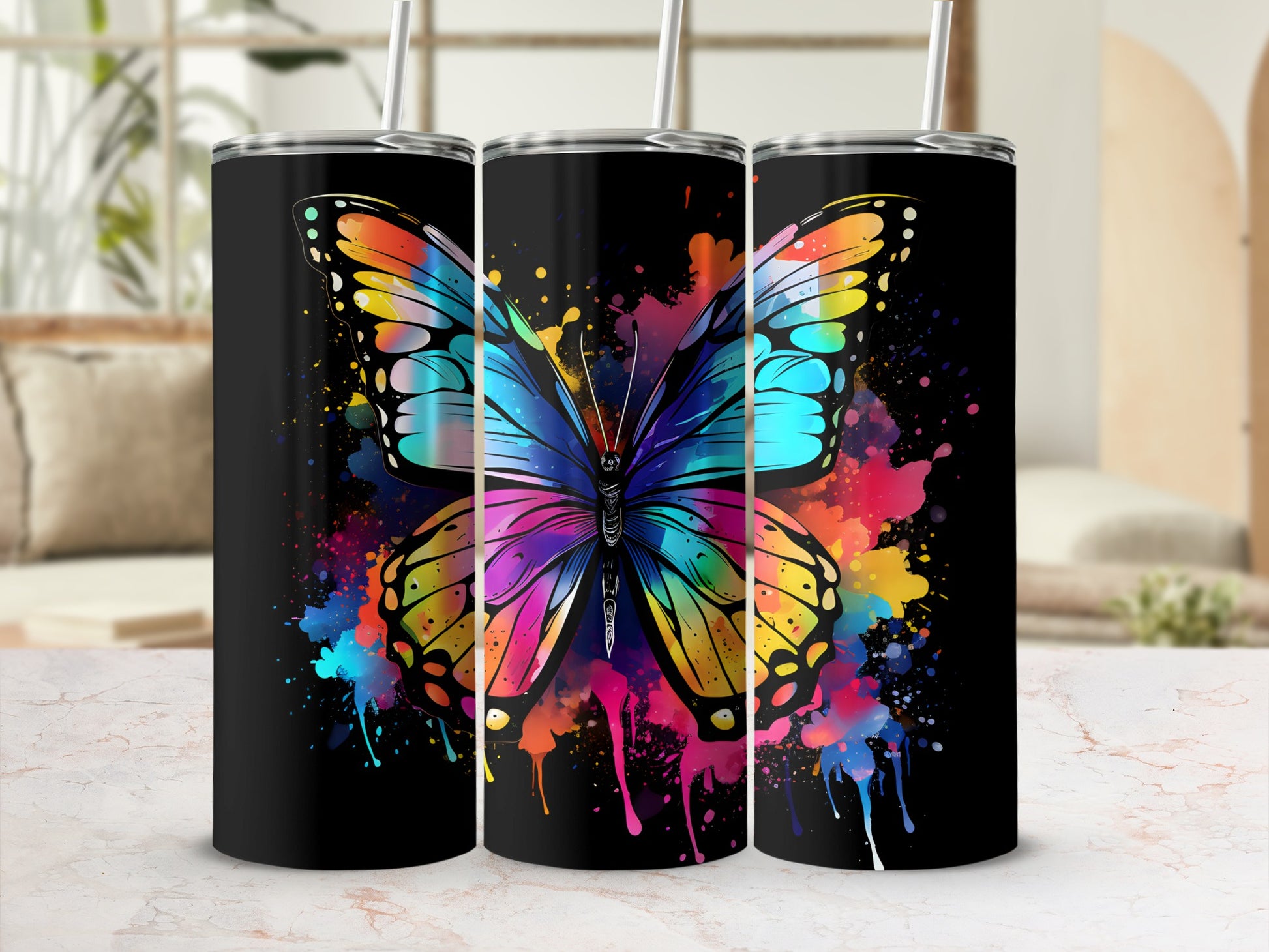 Black tumbler with vibrant rainbow butterfly and paint splatter design.