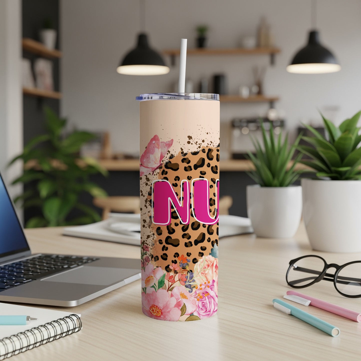 Tumbler with "NU" logo, leopard print, and floral accents.