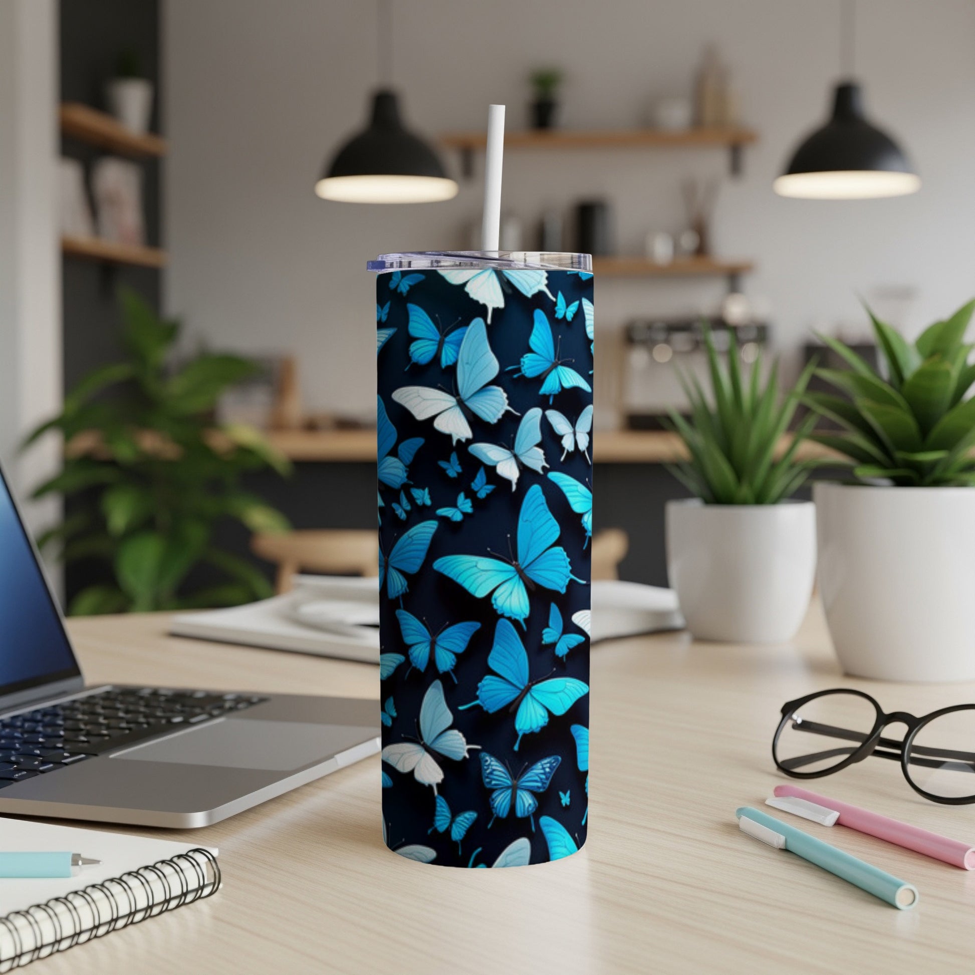 Blue butterfly pattern on a white skinny tumbler with a straw.