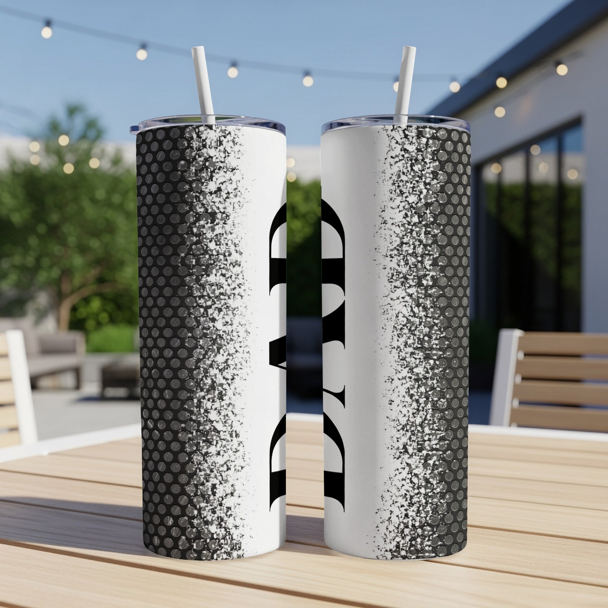 Two tumblers with "DAD" text and a textured pattern on a wooden table.