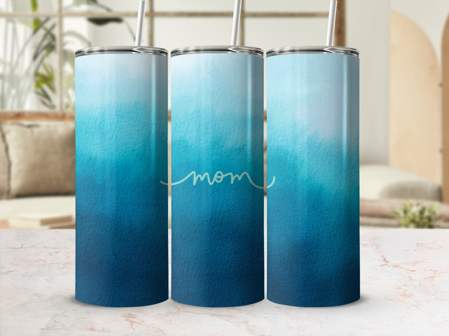 Blue and white ombre gradient tumbler with "mom" text.
