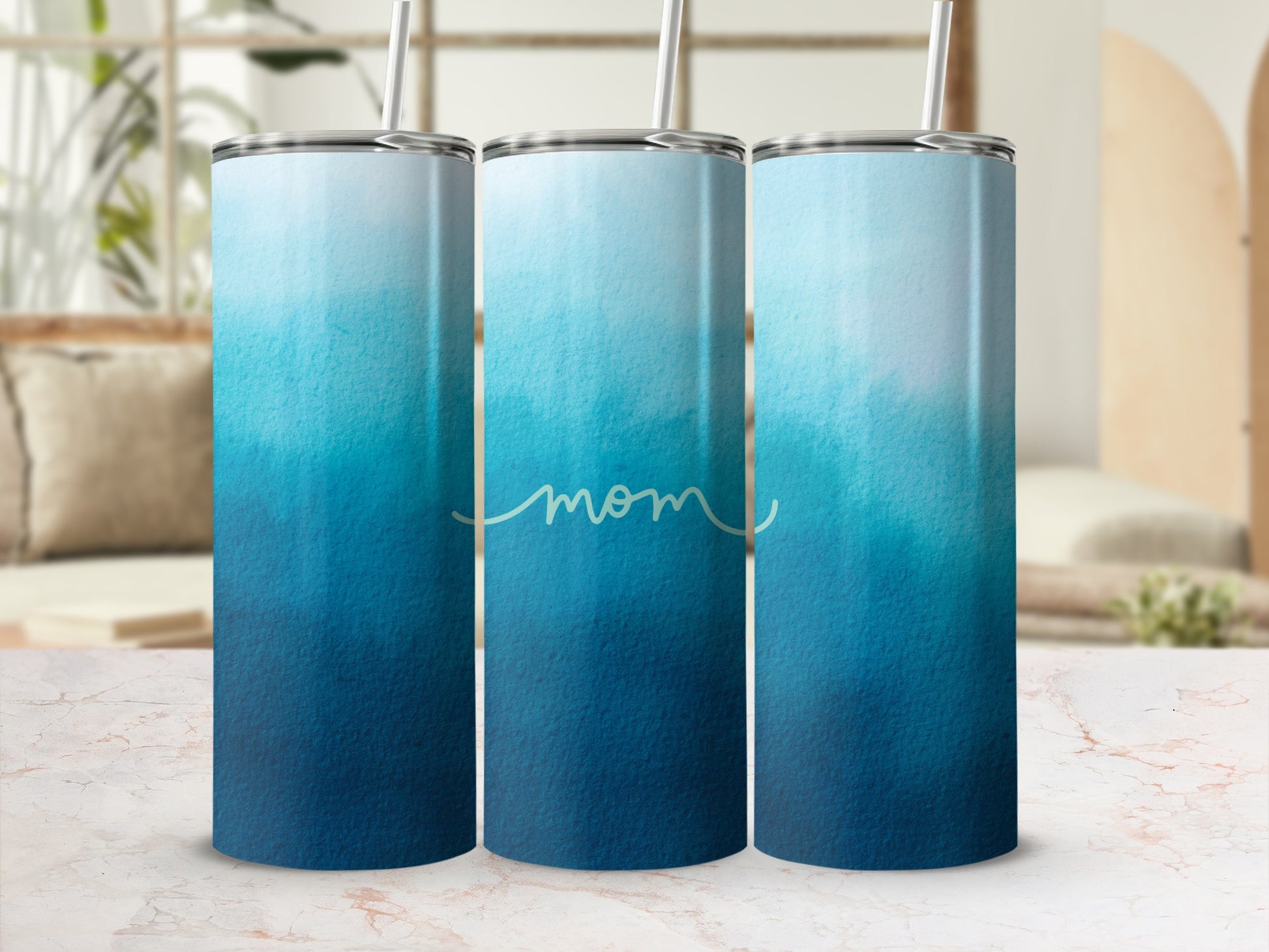 Blue and white ombre gradient tumbler with "mom" text.