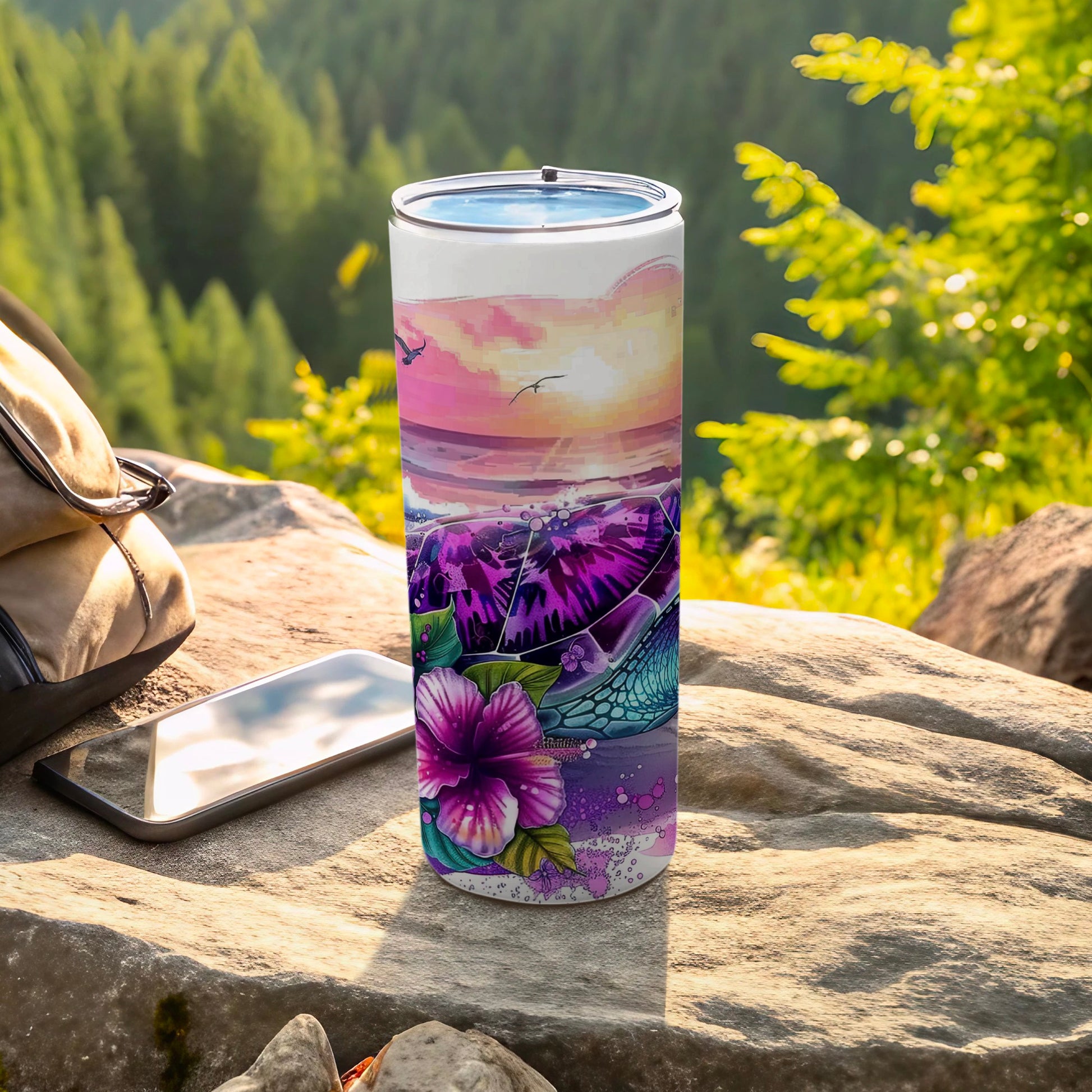 Purple turtle and hibiscus flower design on a tumbler with scenic background.