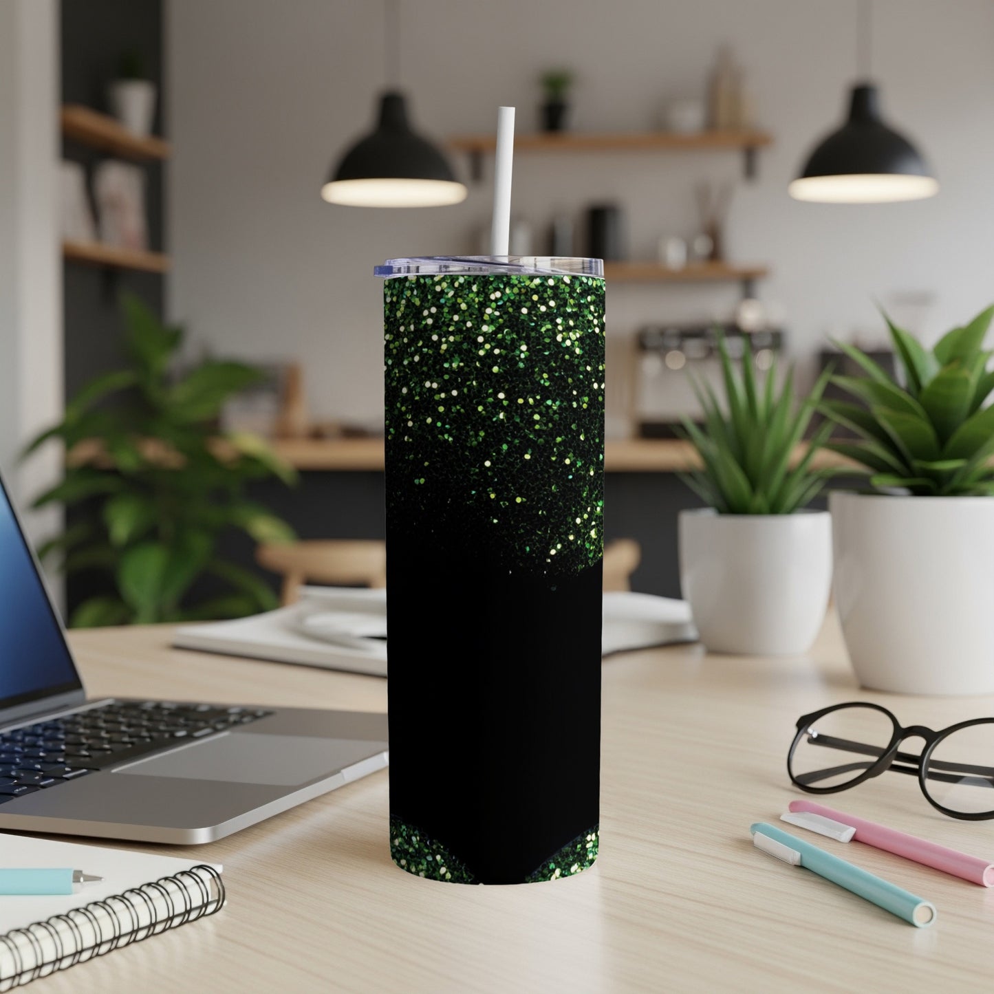Black tumbler with green glitter gradient and white lid and straw.