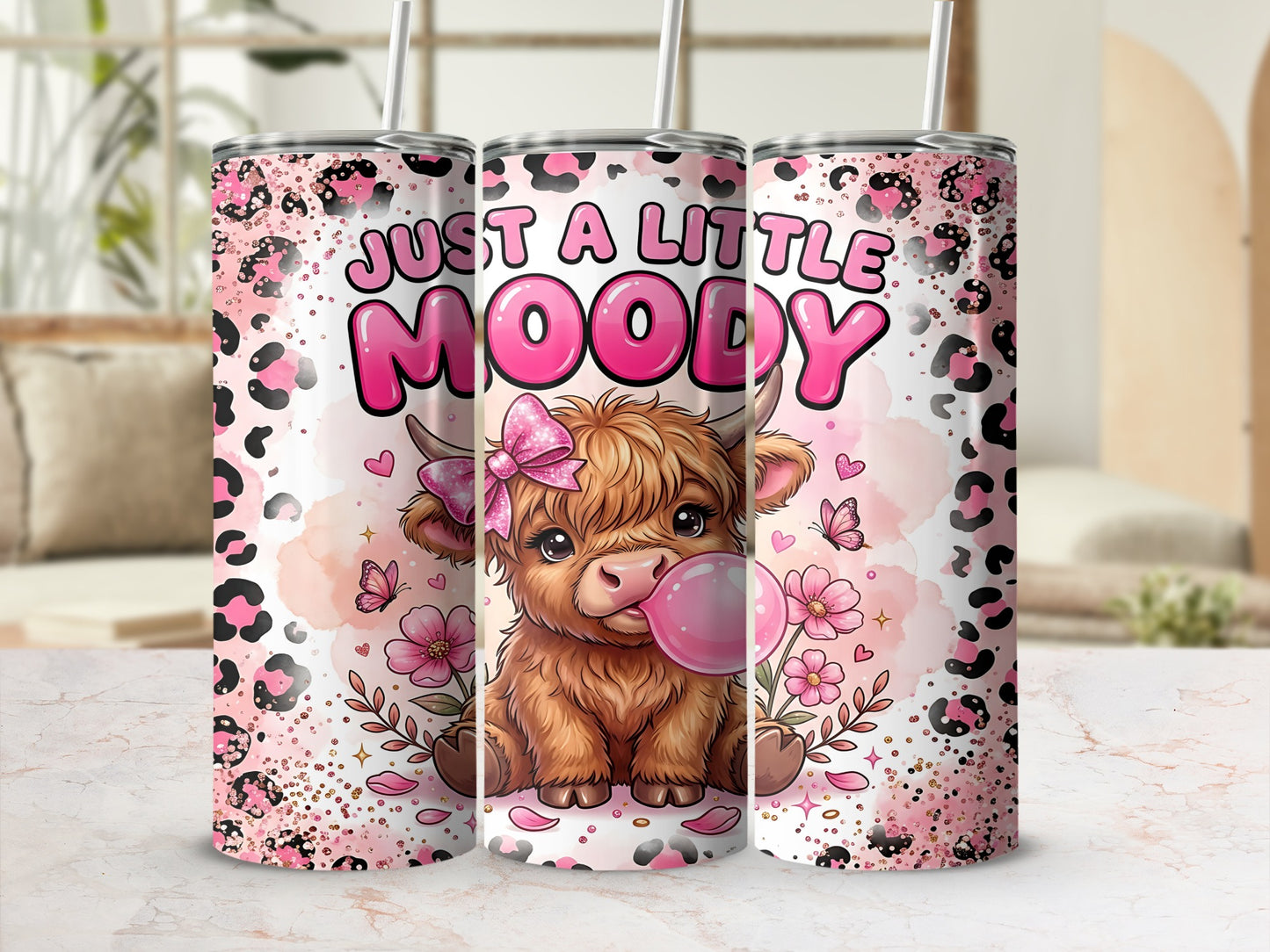 Highland cow with "JUST A LITTLE MOODY" text on a pink leopard print tumbler.