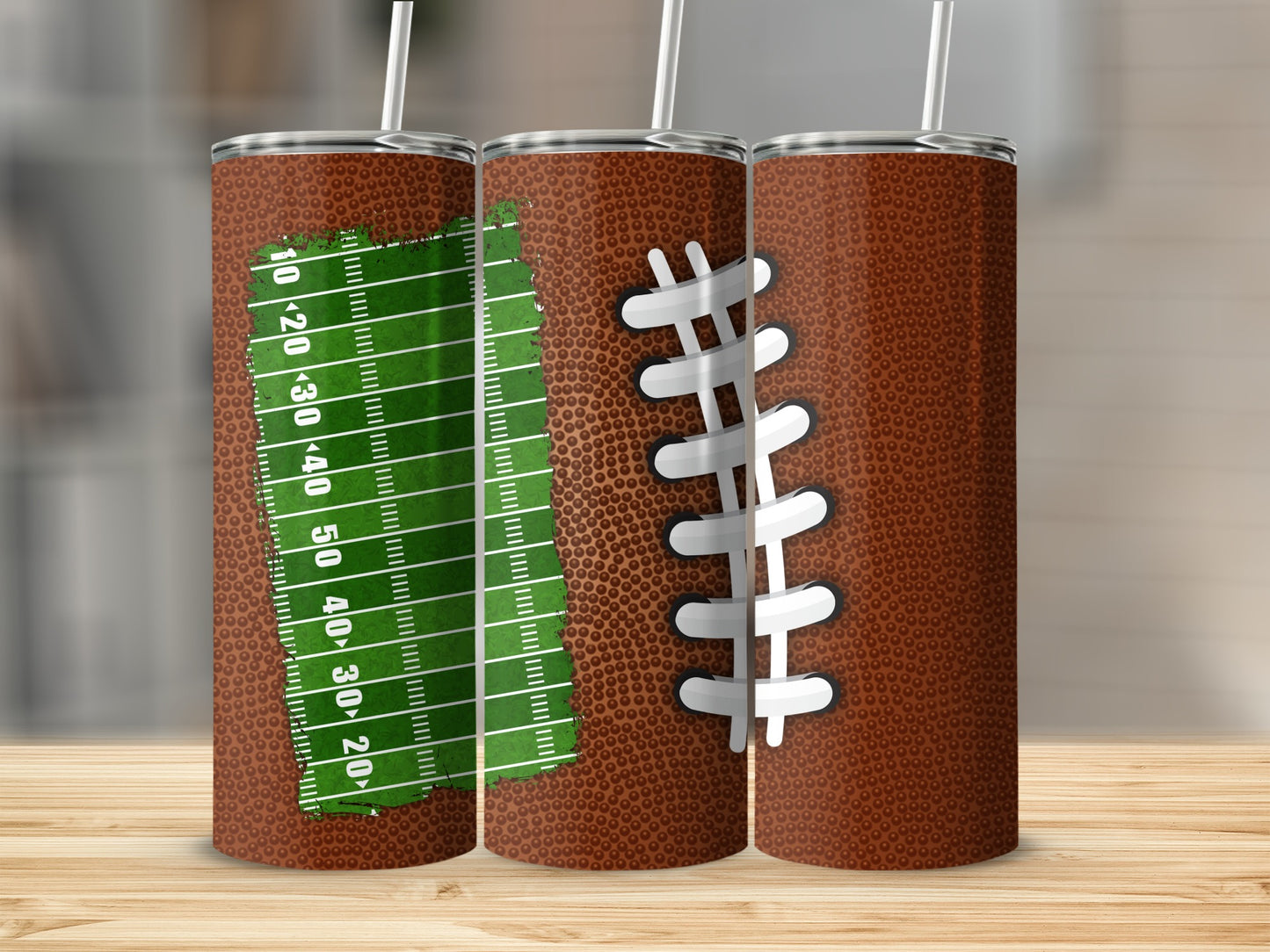 Football-themed tumbler with a green field and lacing detail.