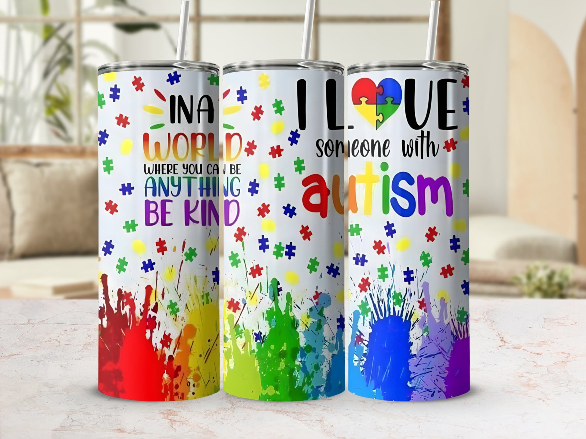 Three colorful tumblers with autism awareness phrases and puzzle piece designs.