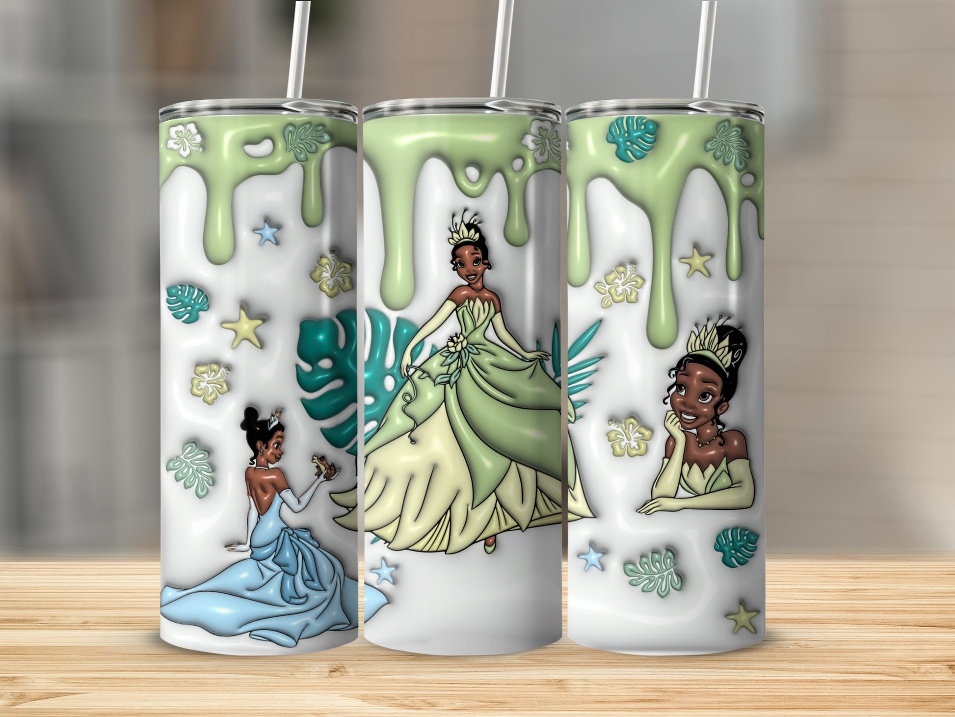 Three tumblers featuring Princess Tiana in different green and blue ballgowns.