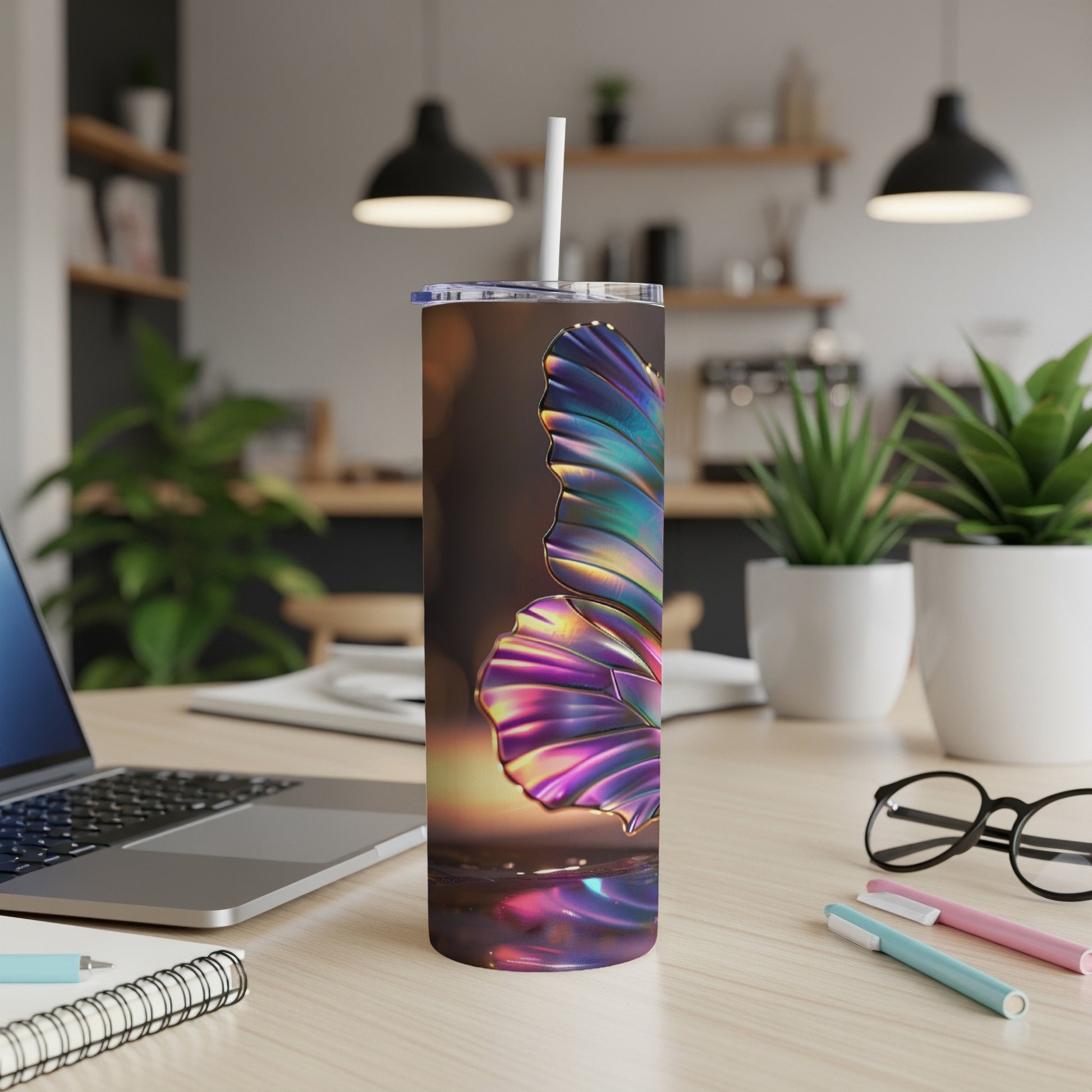 Iridescent butterfly tumbler with straw on desk.