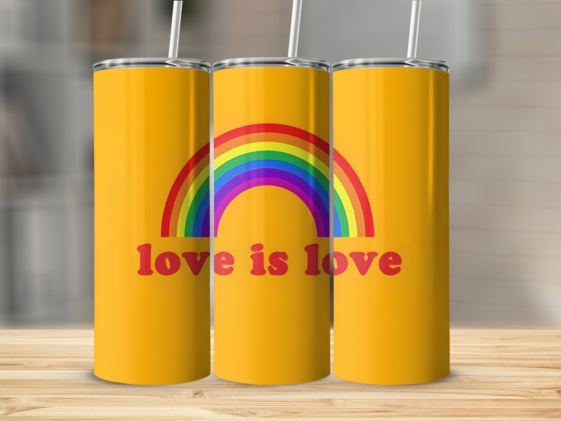 Yellow tumbler with rainbow and "love is love" text.