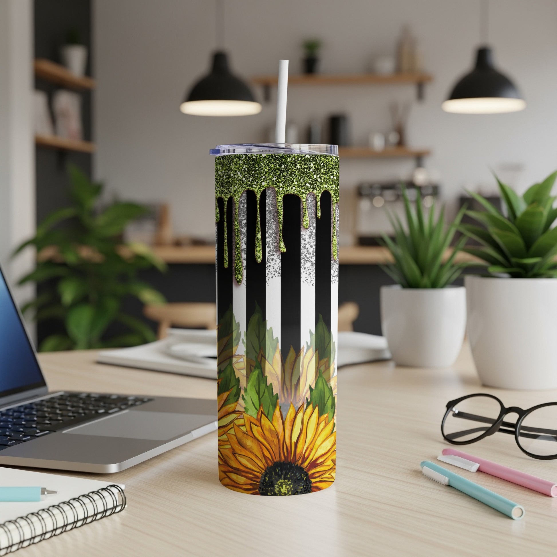 Black and white striped tumbler with glittery green drip and sunflower at bottom.