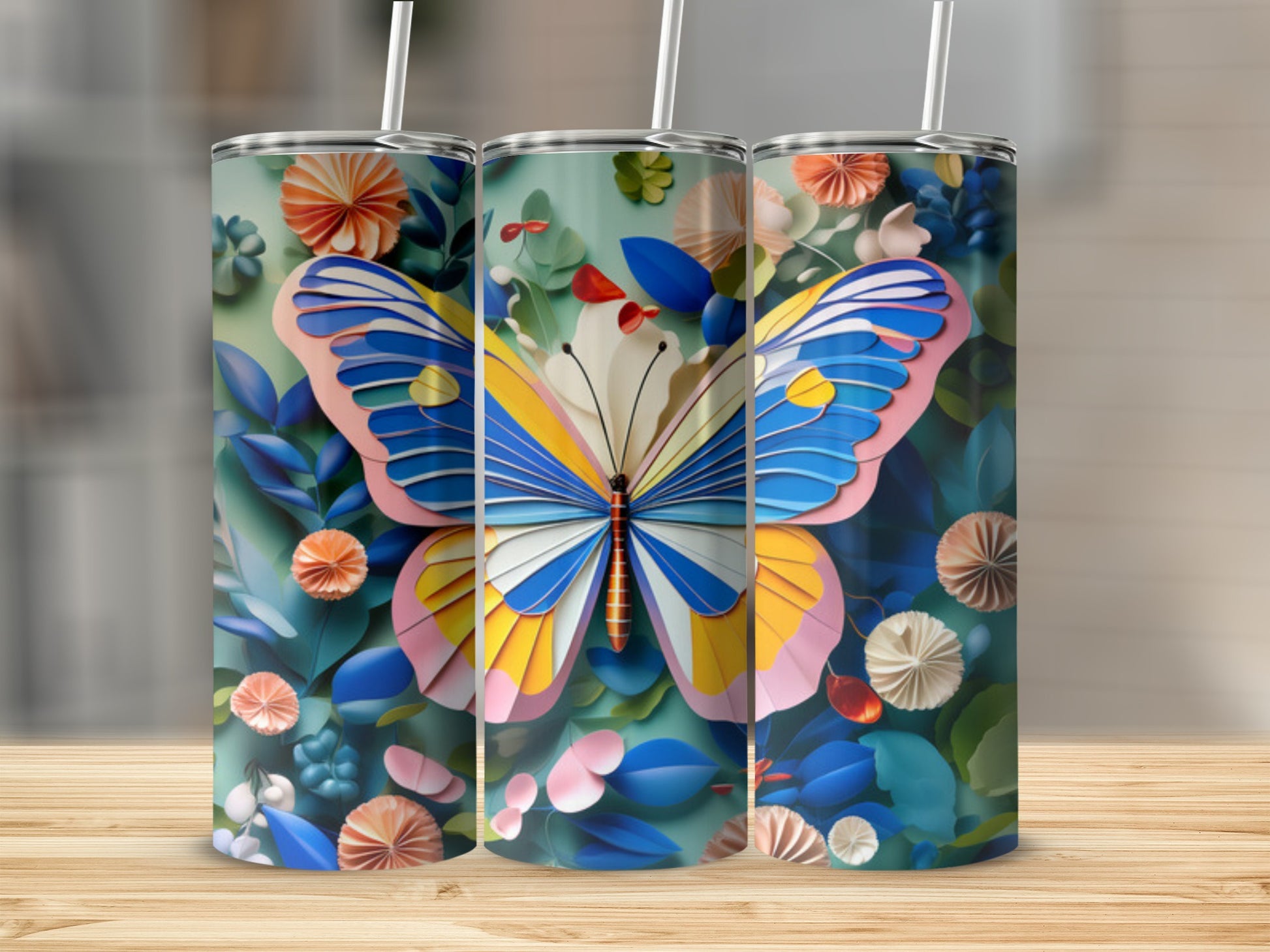 Three tumblers featuring a colorful butterfly and floral design.