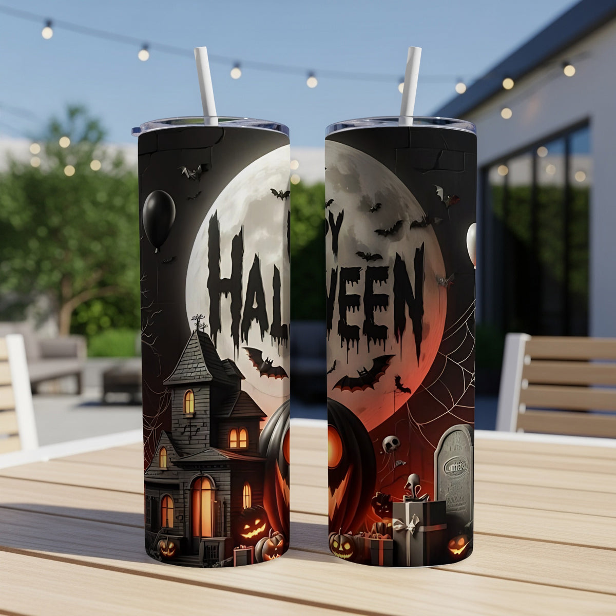 Two tumblers with a spooky Halloween scene featuring a haunted house, pumpkins, and bats.