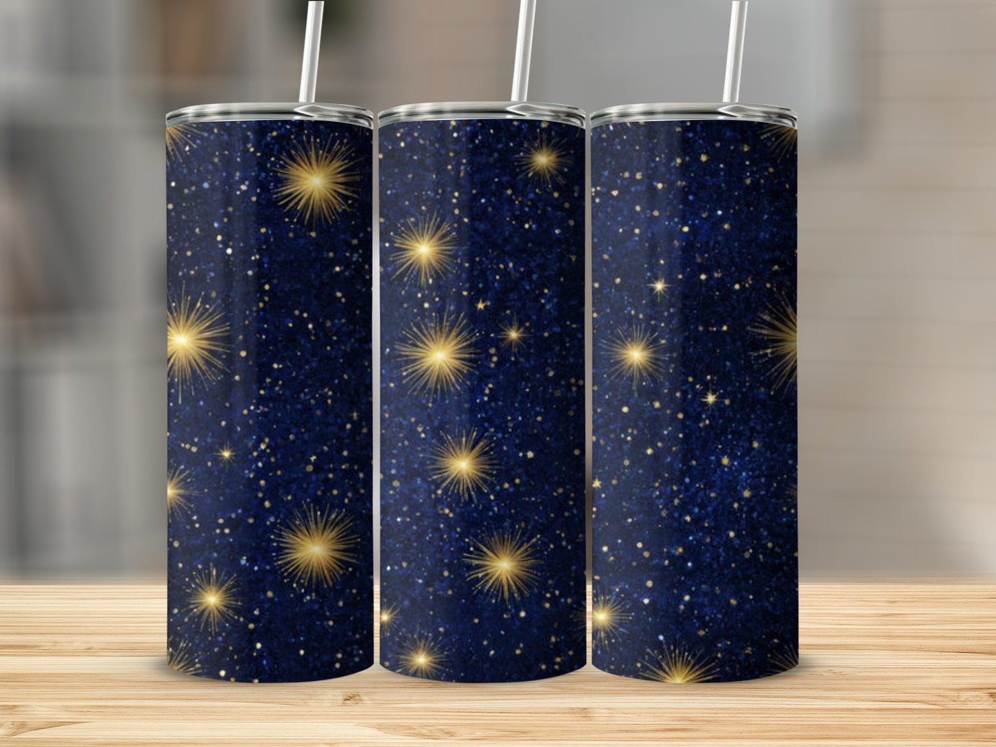 Dark blue tumbler with scattered gold glitter and starbursts.