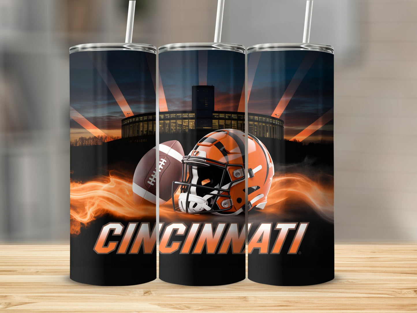 Cincinnati Bengals football helmet and ball with stadium in background.