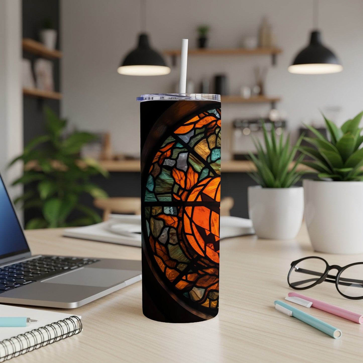 Tall tumbler with stained glass design featuring orange and green patterns.