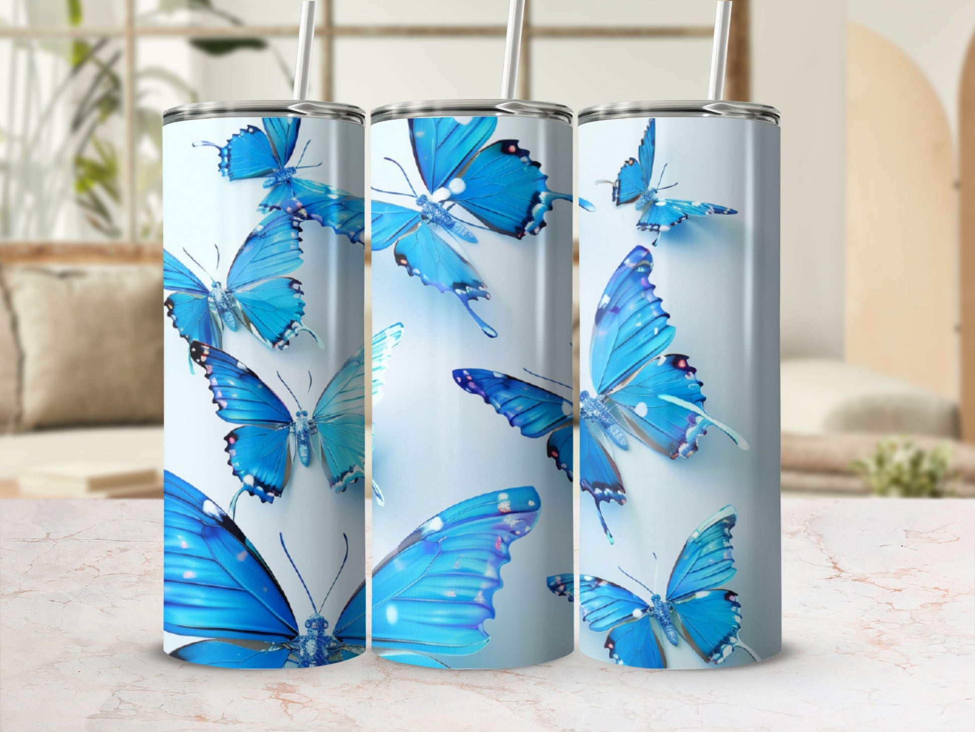 Blue butterflies on a light blue tumbler with a marble textured background.