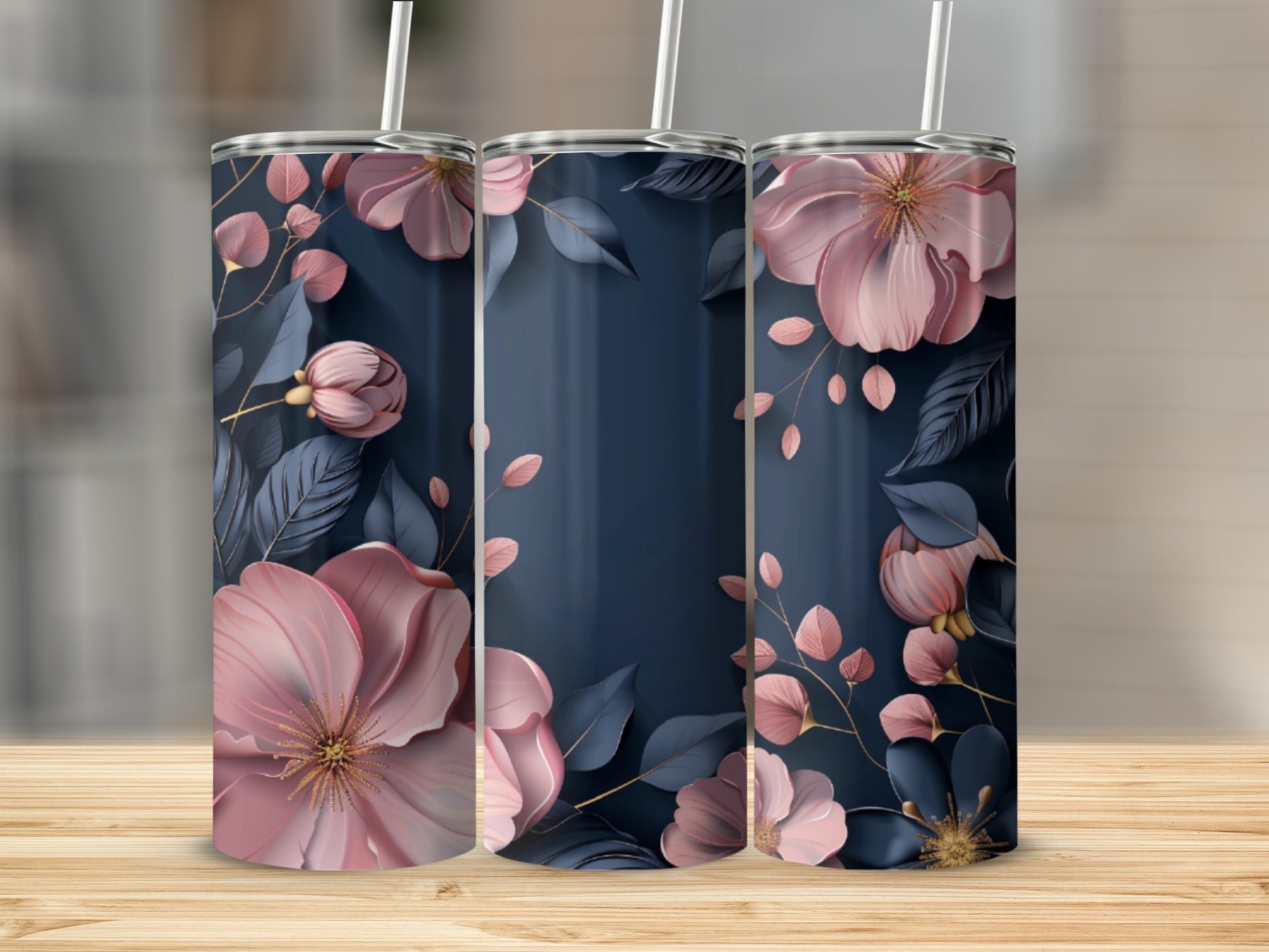Three tumblers with floral design on a wooden surface.