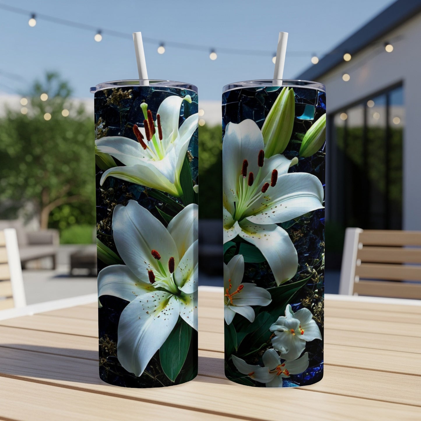 Two white lilies with dark green leaves wrap around a dark blue textured tumbler.