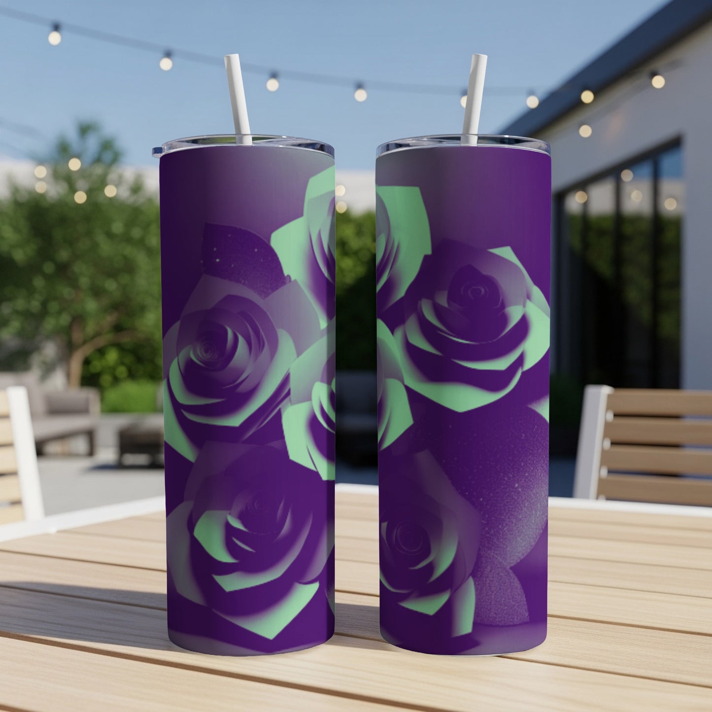 Purple tumbler with mint green roses, on a wooden table outdoors.