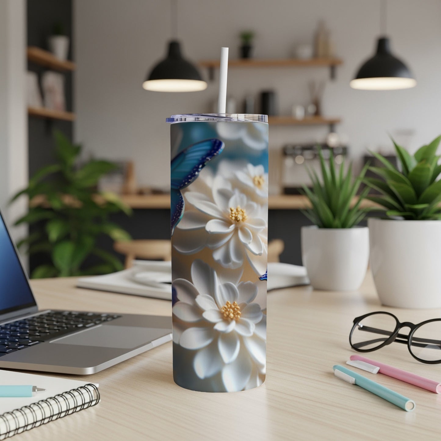 Blue butterfly and white flowers on a tumbler with a straw.