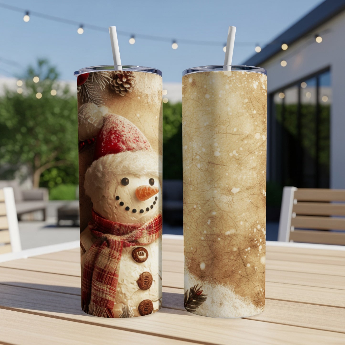 Two tumblers with snowman and festive pattern design on a table.