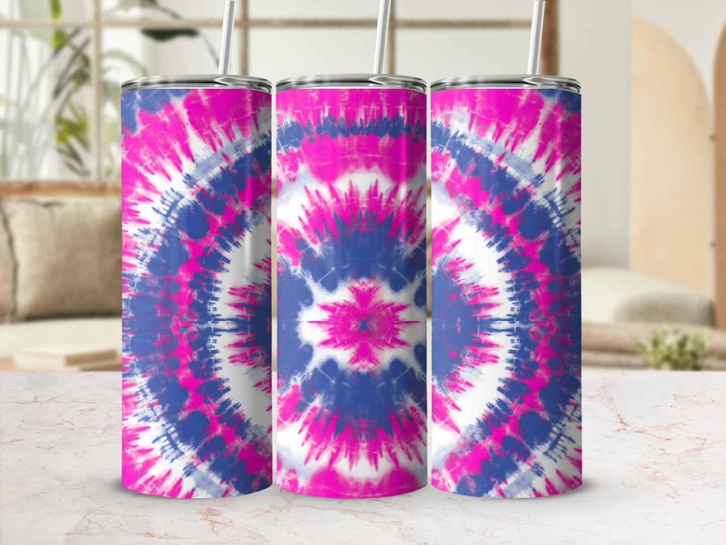 Three tumblers with pink, blue, and white tie-dye patterns and straws.