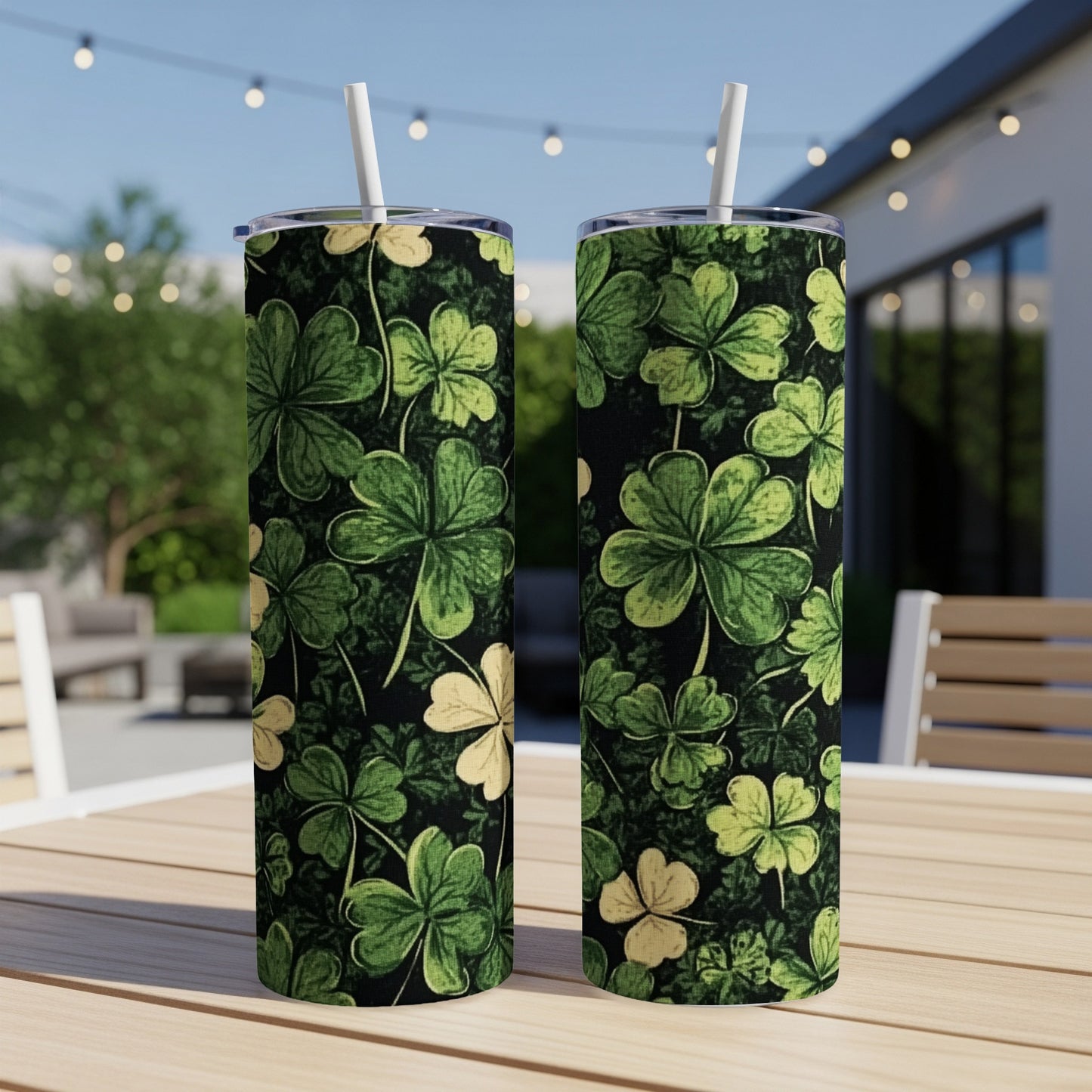 Two tall tumblers with a dark background and a pattern of green and yellow shamrocks.