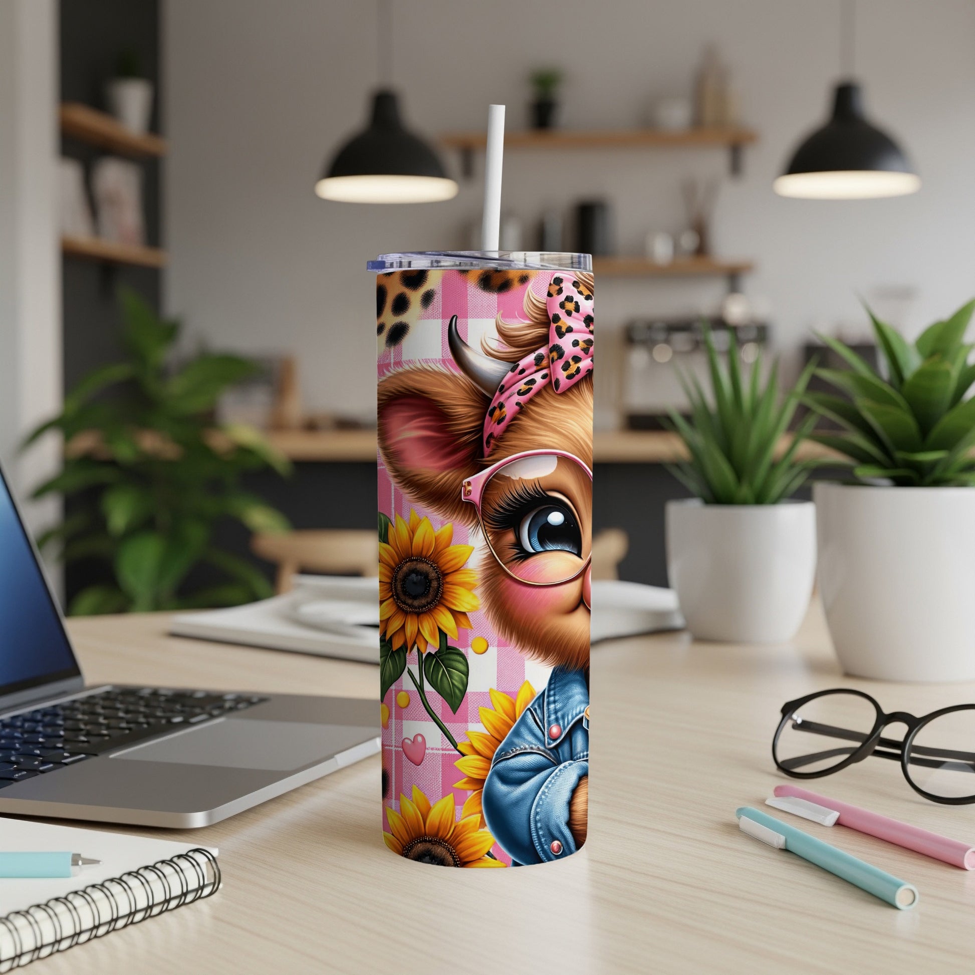 Pink plaid tumbler with cartoon cow, sunflowers, and straw.