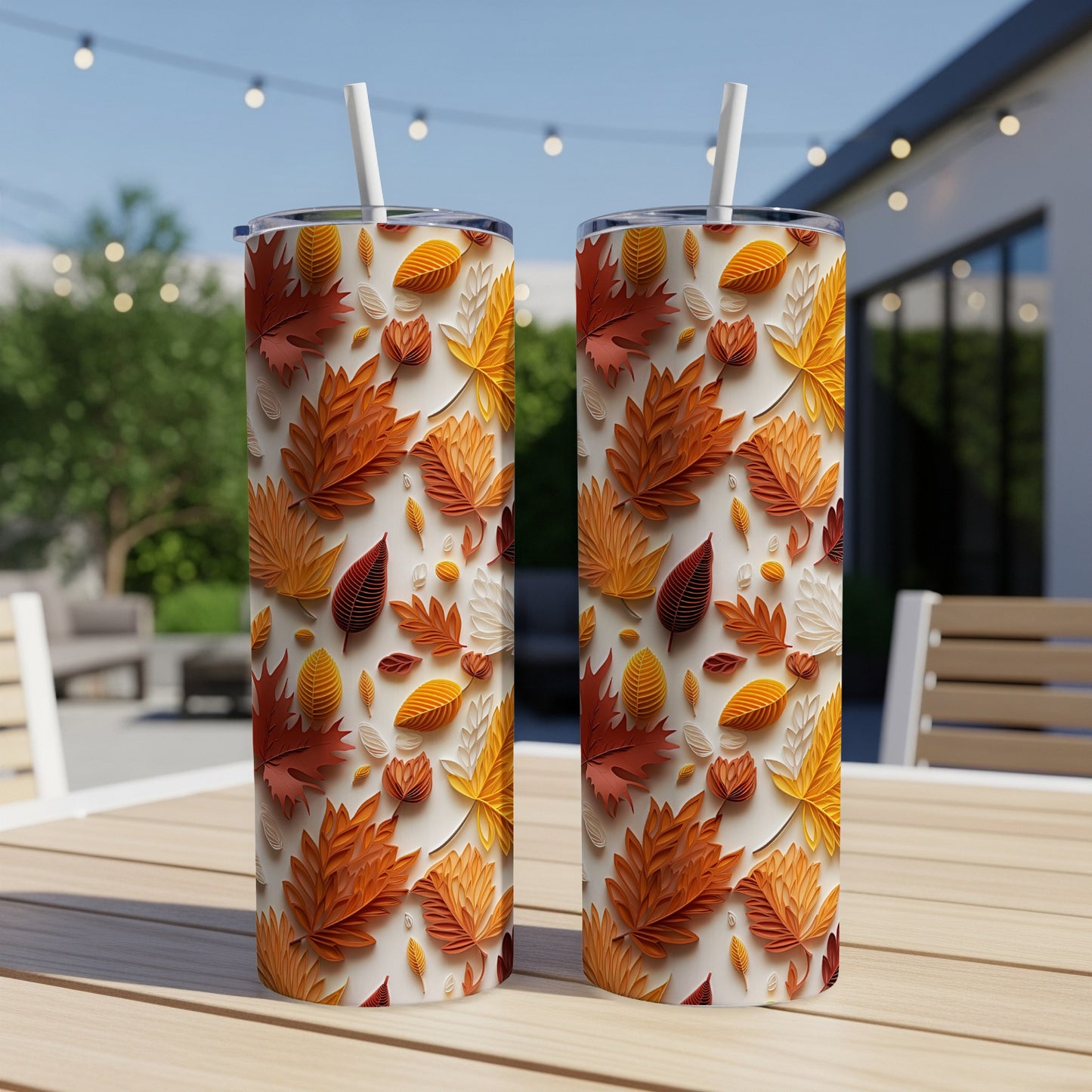 Two tumblers with a textured autumn leaf pattern sit on a wooden table.
