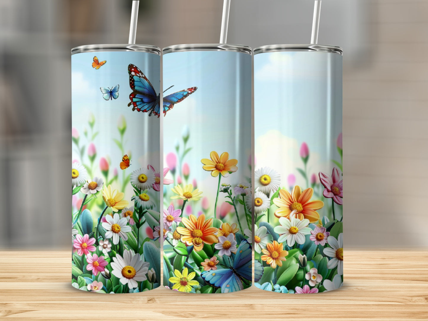 Three tumblers with a floral and butterfly design.