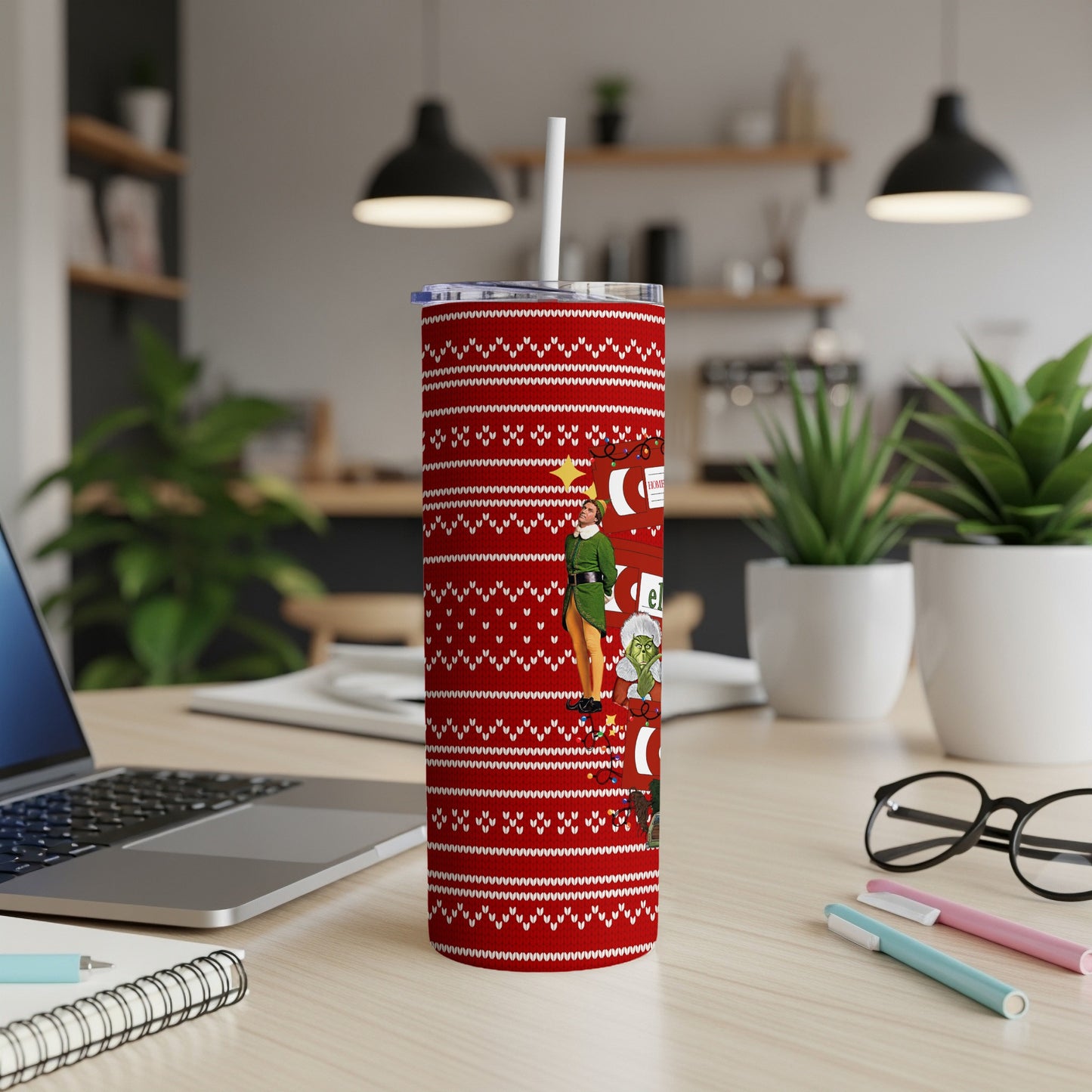 Red tumbler with white snowflake pattern and Christmas characters.