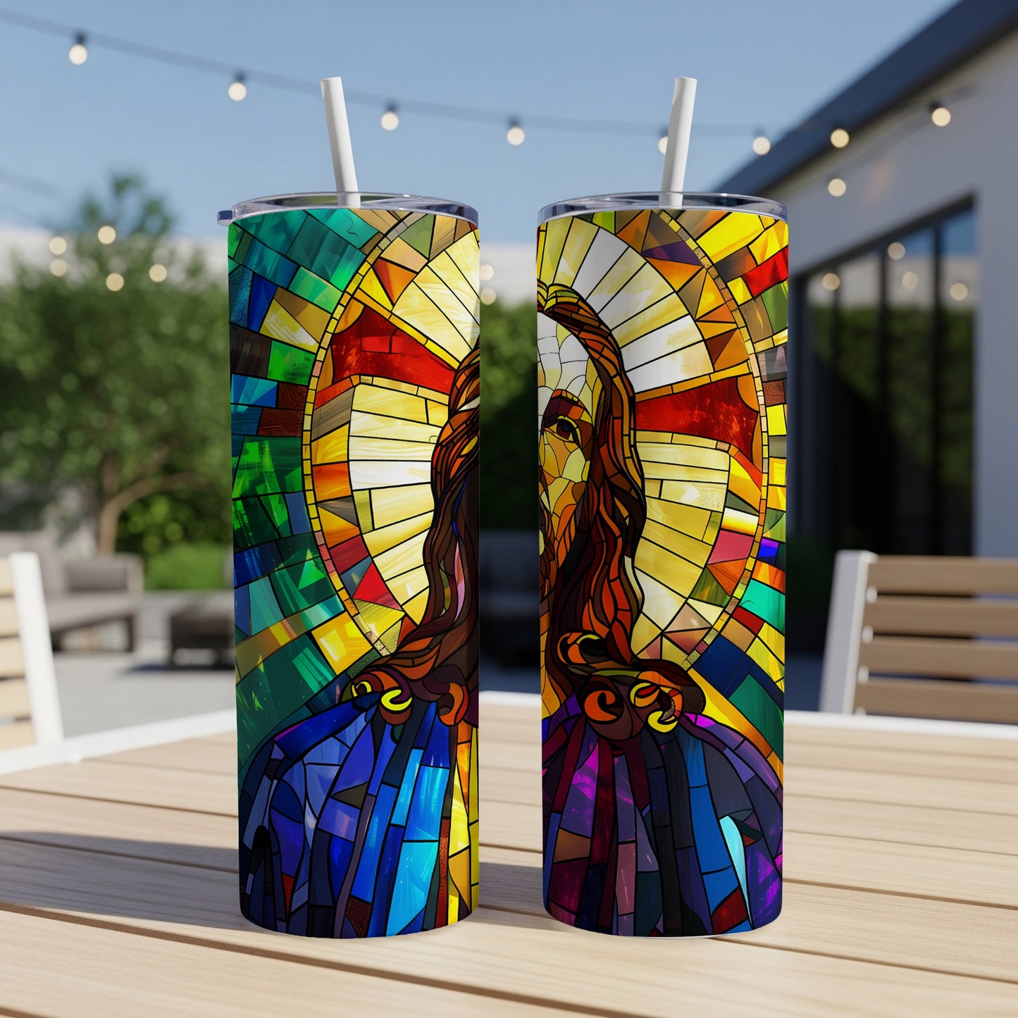 Two tumblers with stained glass imagery of Jesus Christ on a table.