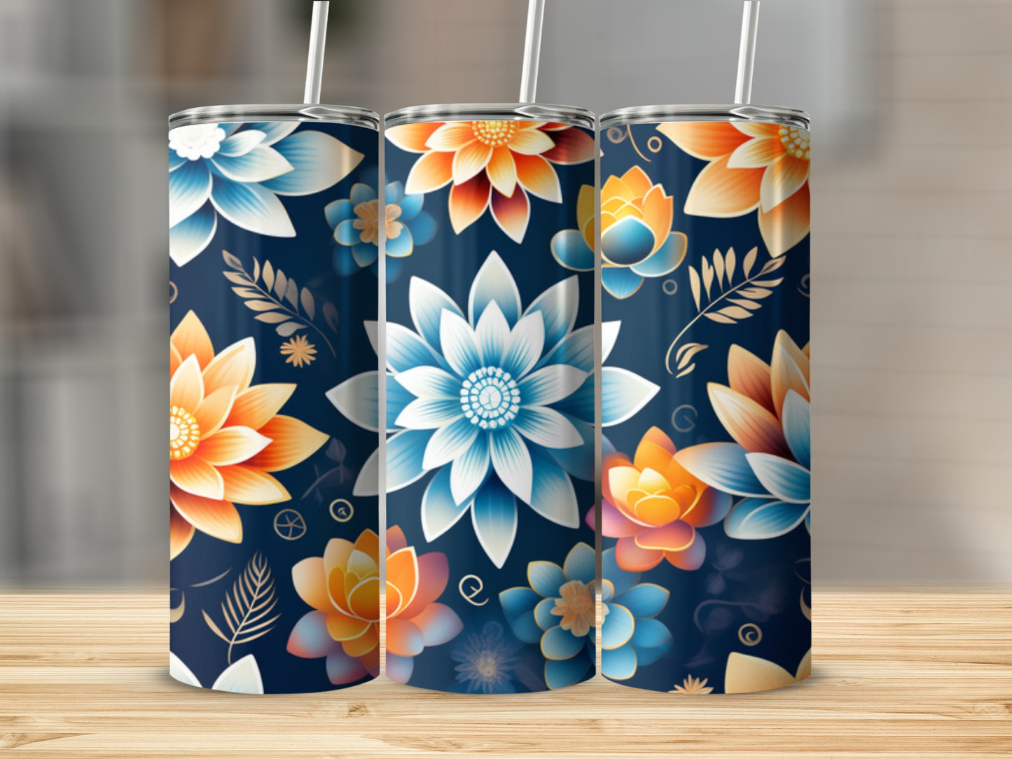 Three floral pattern tumblers with straws on a wooden surface.