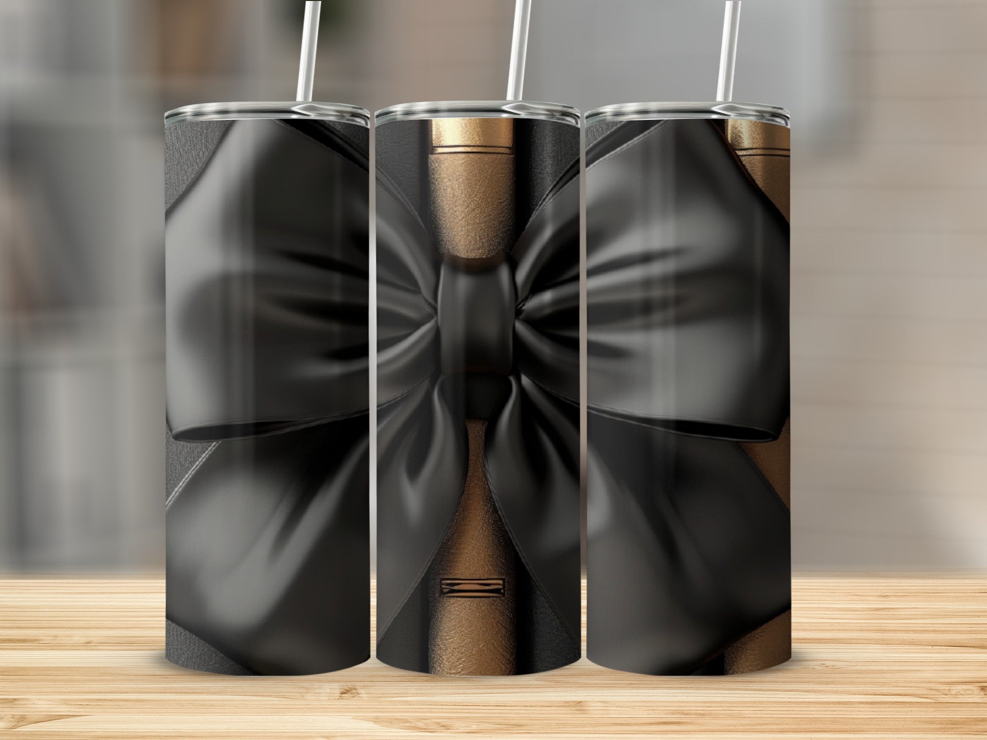 Three tumblers with black bows on a wood background.
