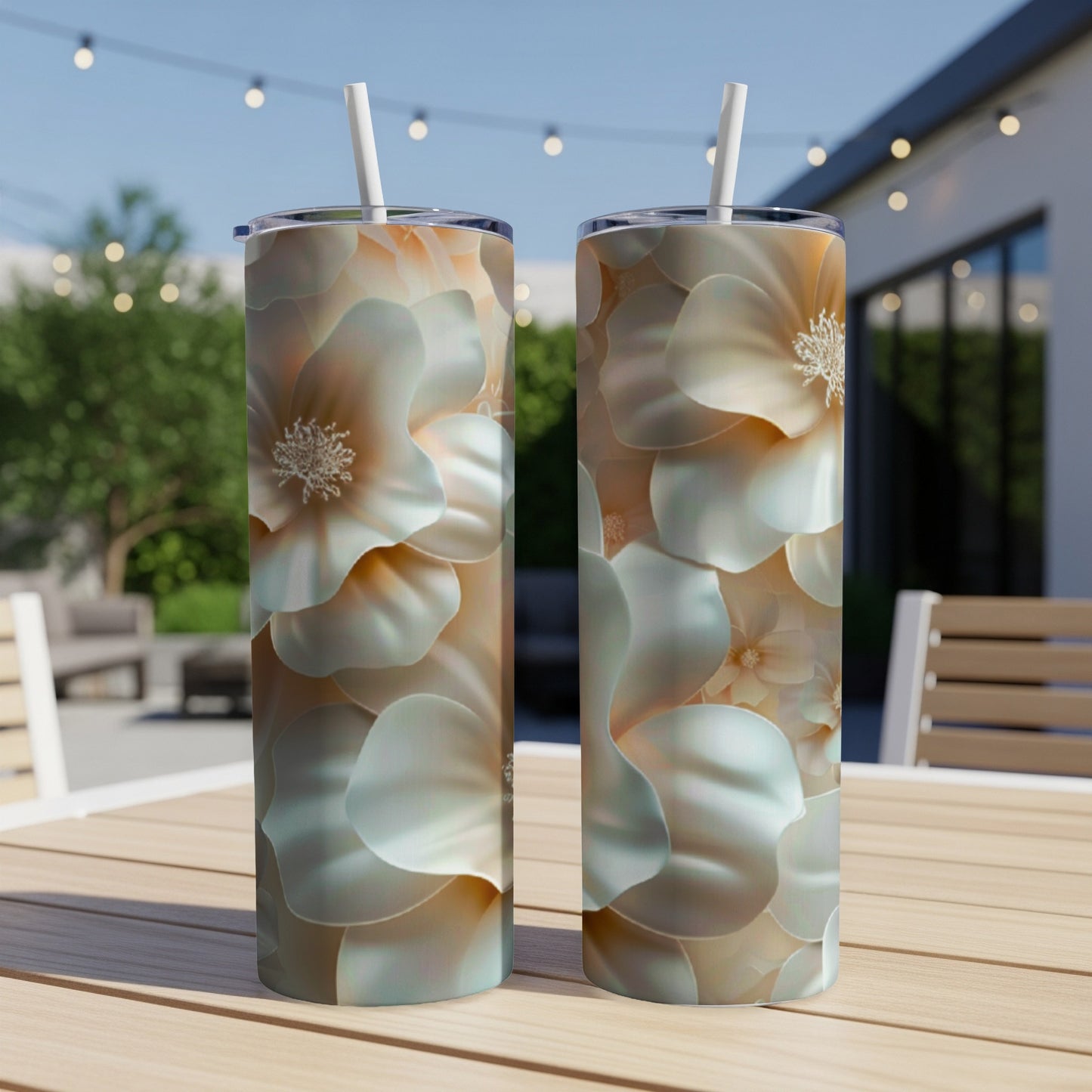 Two tumblers featuring pale floral patterns on a wooden table.