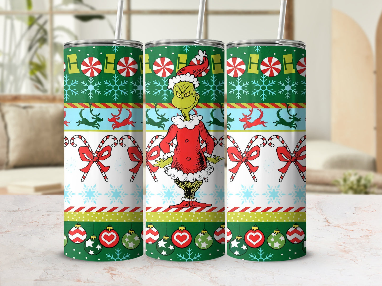 The Grinch wearing a Santa suit on a festive Christmas tumbler.