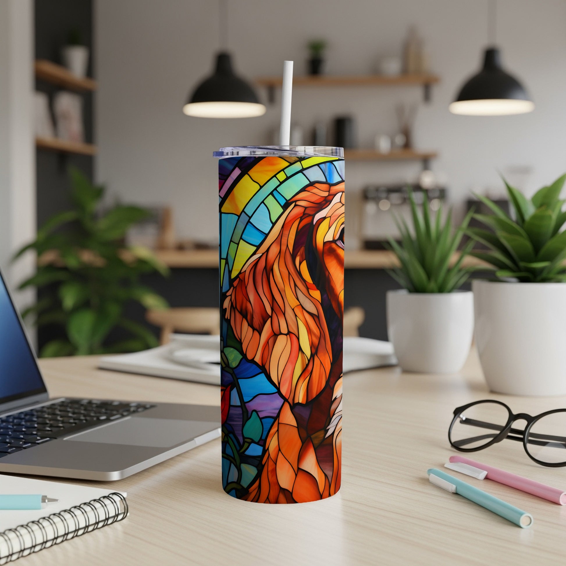 Tall tumbler with stained glass lion design and a straw.