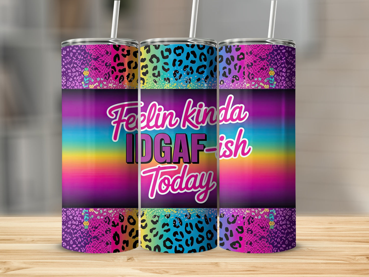 Purple leopard print tumbler with rainbow gradient and "Feelin kinda IDGAF-ish Today" text.