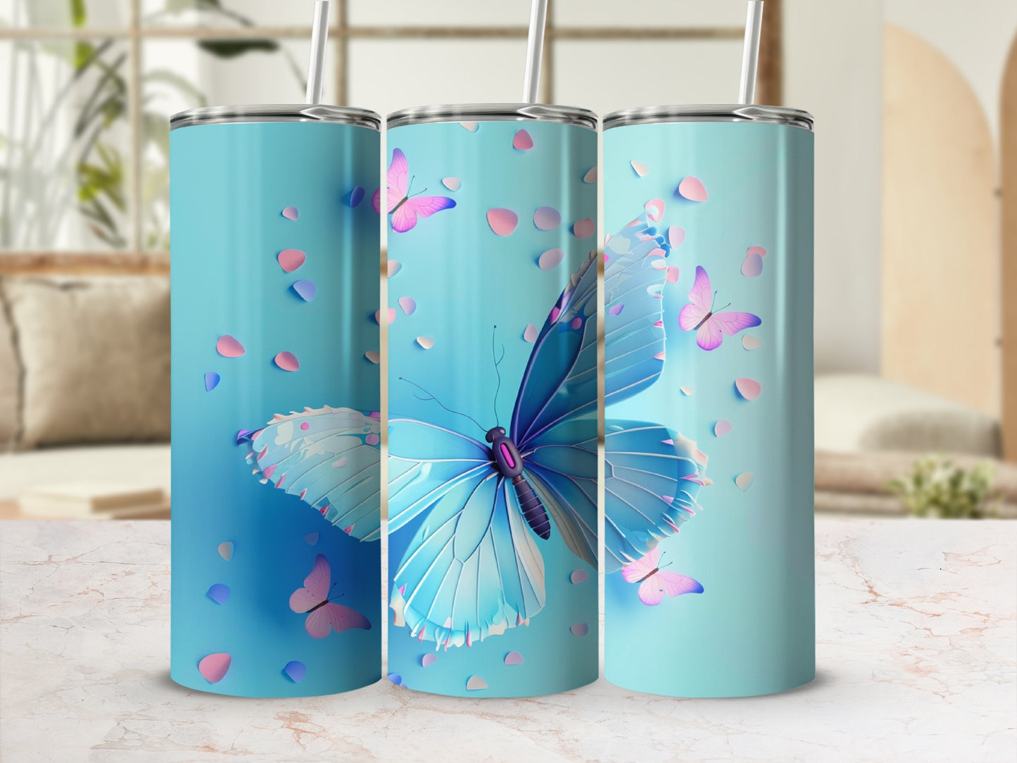 Three blue tumblers with light blue and pink butterflies and petals.