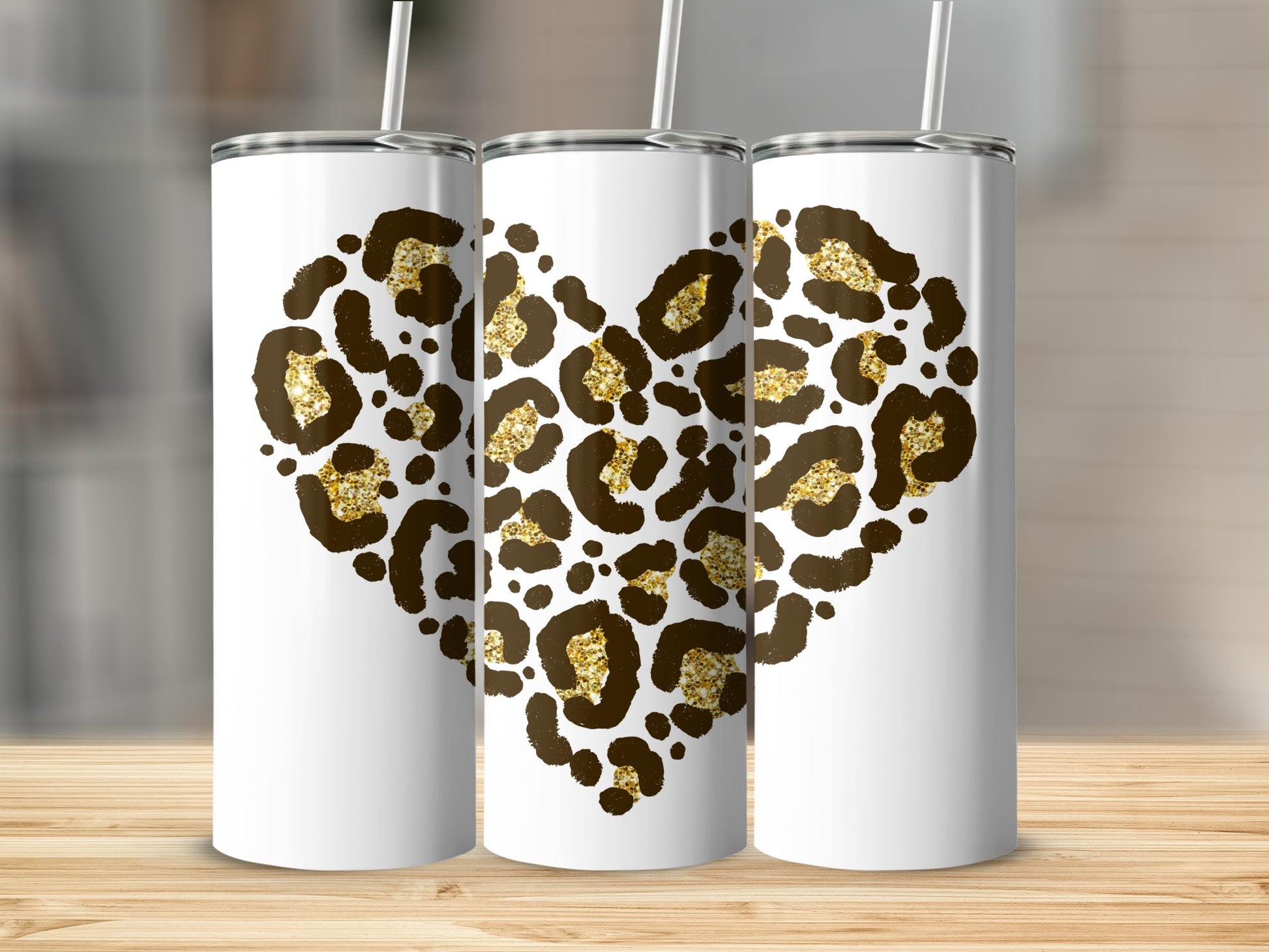 Three white tumblers with leopard print hearts and gold glitter accents.