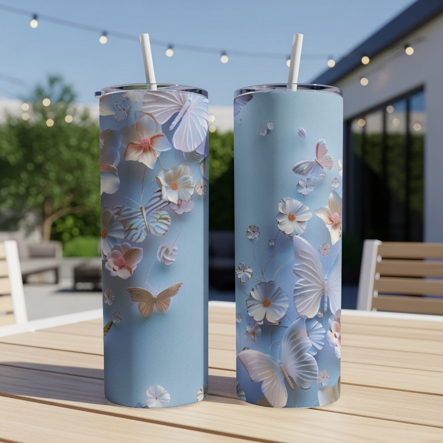 Two light blue tumblers with a delicate butterfly and floral pattern.