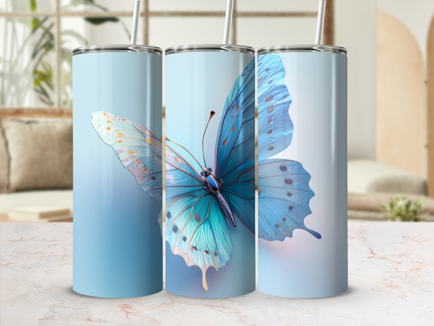 Blue butterfly design on three insulated tumblers with straws.
