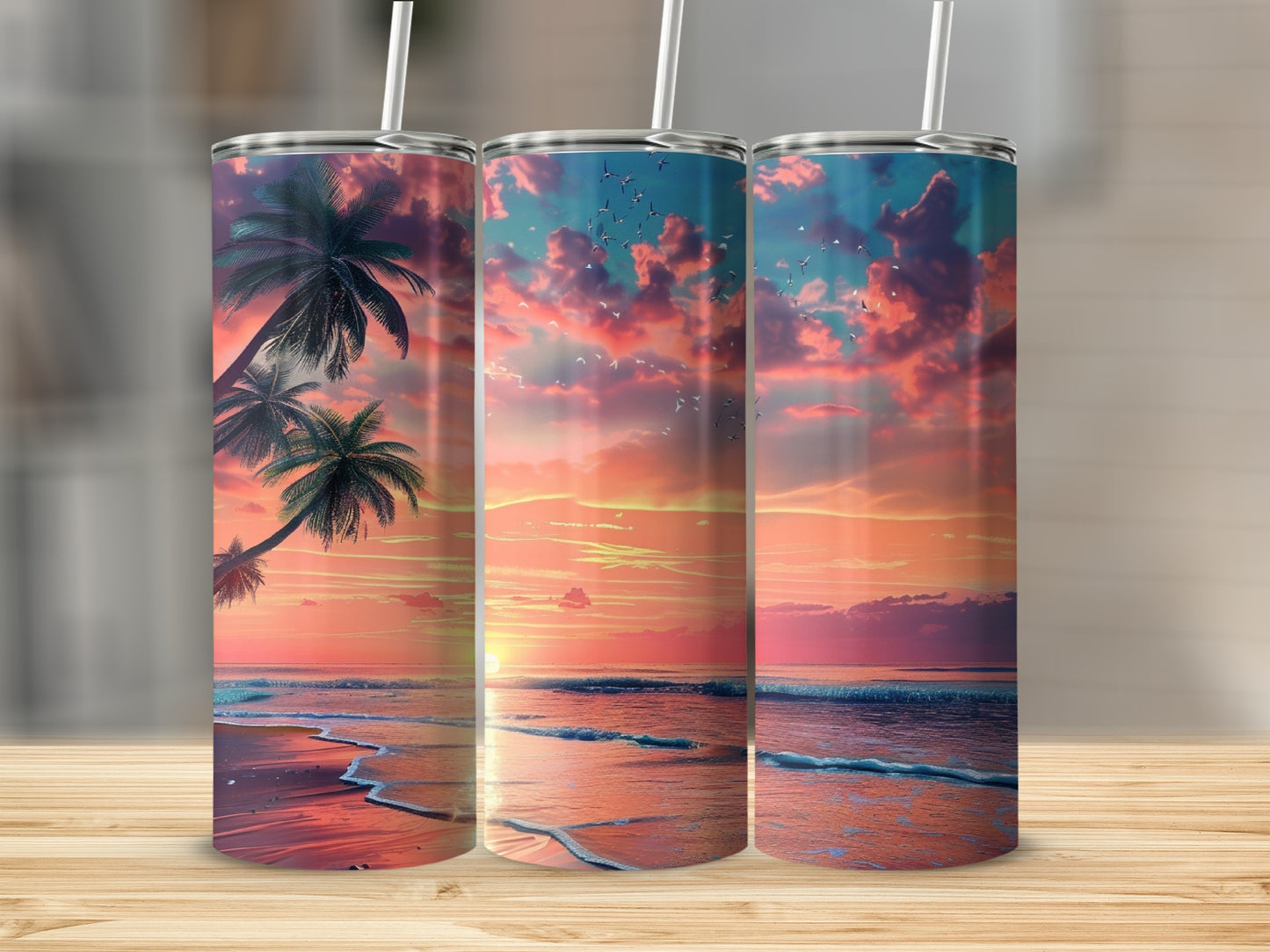 Three tumblers displaying a vibrant beach sunset with palm trees and birds.