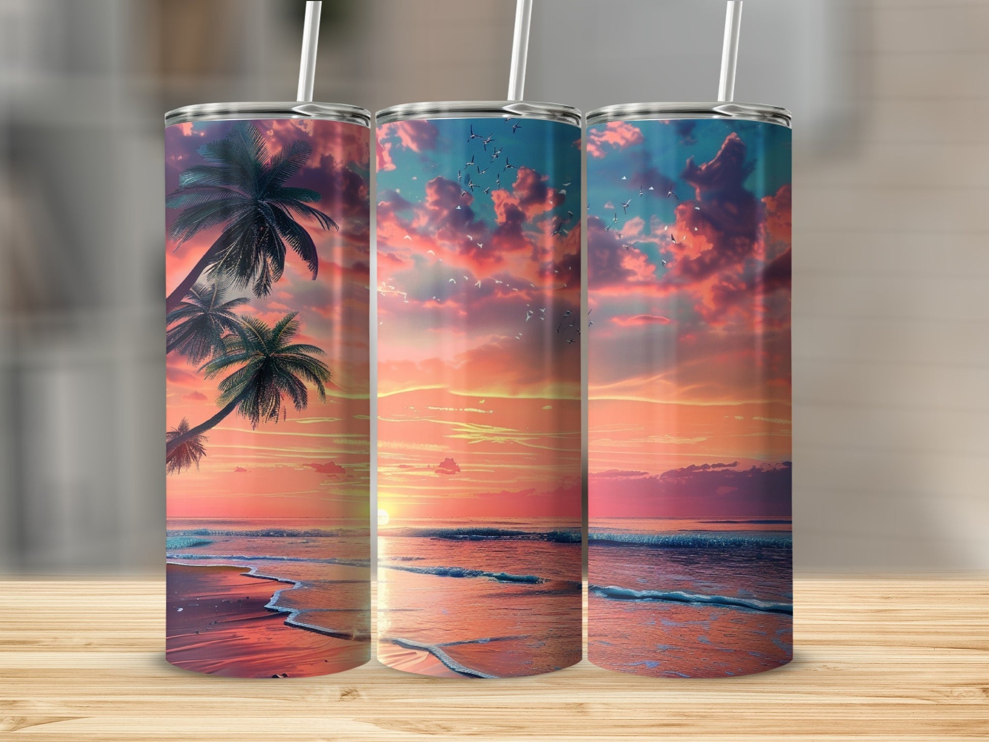 Three tumblers displaying a vibrant beach sunset with palm trees and birds.