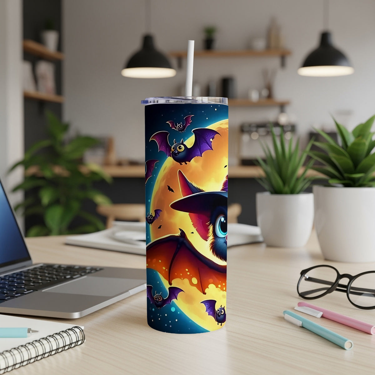Tumbler with cartoon bats flying in front of a large full moon and starry sky.