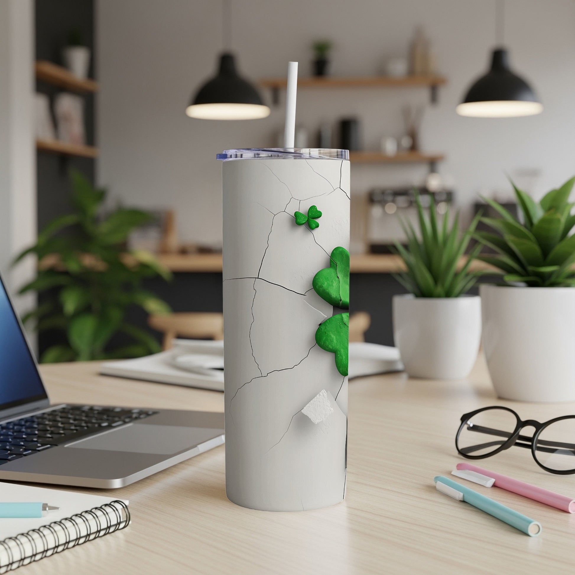 White tumbler with cracked concrete design and green shamrock.